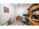 Home office with built-in wooden desk and ample shelving at 1022 E Hiddenview Dr, Phoenix, AZ 85048