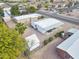 Overhead view of a modest home with a small shed, carport, minimal landscaping and a fenced yard near paved street at 104 N 114Th St, Apache Junction, AZ 85120