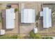 An aerial view of three single-story homes with metal roofs and compact desert landscaping at 104 N 114Th St, Apache Junction, AZ 85120