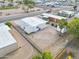 An aerial view displays a tidy residence with minimal landscaping; carport and storage, next to park and neighbors at 104 N 114Th St, Apache Junction, AZ 85120