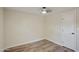 Bright bedroom with modern ceiling fan, wood-look floors and white trim and doors at 104 N 114Th St, Apache Junction, AZ 85120