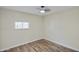 An empty bedroom with a modern ceiling fan, light walls and wood-style flooring at 104 N 114Th St, Apache Junction, AZ 85120