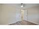Bright bedroom with wood-look floors, ceiling fan and white doors leading to other rooms at 104 N 114Th St, Apache Junction, AZ 85120