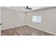 An empty bedroom with a modern ceiling fan and wood-style flooring at 104 N 114Th St, Apache Junction, AZ 85120