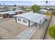 Aerial shot showcases a tidy single-story home with a carport, surrounded by low-maintenance gravel landscaping at 104 N 114Th St, Apache Junction, AZ 85120