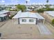 A charming exterior aerial view of a well-maintained single-story residence with a carport and gravel yard at 104 N 114Th St, Apache Junction, AZ 85120