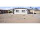 Charming single-story home with desert landscaping and white exterior featuring gray accents at 104 N 114Th St, Apache Junction, AZ 85120