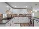 Modern kitchen features white cabinets, stainless steel appliances, and beautiful backsplash at 104 N 114Th St, Apache Junction, AZ 85120
