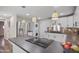 Modern kitchen featuring stainless steel appliances, stacked washer/dryer, and beautiful pendant lighting at 104 N 114Th St, Apache Junction, AZ 85120
