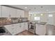 Bright kitchen featuring white cabinetry, stainless steel range, and wooden-style floors at 104 N 114Th St, Apache Junction, AZ 85120