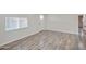 Bright and airy living room with a large window, modern flooring, and neutral walls at 104 N 114Th St, Apache Junction, AZ 85120