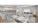 Open-concept living space with modern kitchen, dining area, and comfortable living room featuring bright natural light at 104 N 114Th St, Apache Junction, AZ 85120