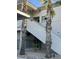 Apartment building exterior featuring stairs, two palm trees, gravel and a view of blue sky at 10401 N Saguaro Blvd # 210, Fountain Hills, AZ 85268