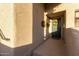 Apartment front door decorated with a wreath and hanging flower baskets at 10401 N Saguaro Blvd # 210, Fountain Hills, AZ 85268
