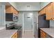 This well-lit kitchen features stainless steel appliances, wooden cabinets, and laminate flooring at 10401 N Saguaro Blvd # 210, Fountain Hills, AZ 85268
