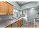 The kitchen features wooden cabinets, stainless steel dishwasher, and a dual basin sink at 10401 N Saguaro Blvd # 210, Fountain Hills, AZ 85268