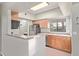The kitchen has wooden cabinets, stainless steel appliances, and a light filled window over the sink at 10401 N Saguaro Blvd # 210, Fountain Hills, AZ 85268