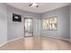 Open living room with wood floors, sliding glass doors, a ceiling fan, and large windows at 10401 N Saguaro Blvd # 210, Fountain Hills, AZ 85268