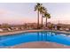 Community pool offers mountain views, lounge seating, and tropical palm trees, perfect for relaxation at 10401 N Saguaro Blvd # 210, Fountain Hills, AZ 85268