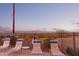 Poolside lounge chairs offer relaxation with views of desert landscape at sunset at 10401 N Saguaro Blvd # 210, Fountain Hills, AZ 85268