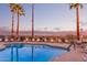 Inviting community pool framed by palm trees and lounge chairs, perfect for relaxation and leisure at 10401 N Saguaro Blvd # 210, Fountain Hills, AZ 85268