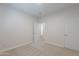 Clean bedroom featuring carpet, double door and view to hallway at 10582 W Salter Dr, Peoria, AZ 85382
