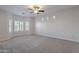 Bright bedroom featuring bay window with shutters and ceiling fan at 10582 W Salter Dr, Peoria, AZ 85382