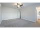 Spacious bedroom with ceiling fan and plush carpeting at 10582 W Salter Dr, Peoria, AZ 85382