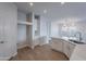Modern kitchen with white cabinets, island, and quartz countertops at 10582 W Salter Dr, Peoria, AZ 85382