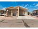 Tan manufactured home with carport and small porch at 11596 W Sierra Dawn Blvd # 5, Surprise, AZ 85378