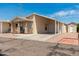 Tan manufactured home with carport and small porch at 11596 W Sierra Dawn Blvd # 5, Surprise, AZ 85378