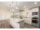 Modern kitchen with white cabinets, stainless steel appliances and an island at 11596 W Sierra Dawn Blvd # 5, Surprise, AZ 85378