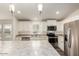 Modern kitchen with white cabinets, stainless steel appliances, and an island at 11596 W Sierra Dawn Blvd # 5, Surprise, AZ 85378