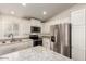 Modern kitchen with white cabinets, stainless steel appliances and an island at 11596 W Sierra Dawn Blvd # 5, Surprise, AZ 85378