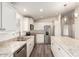 Modern kitchen with white cabinets, stainless steel appliances and an island at 11596 W Sierra Dawn Blvd # 5, Surprise, AZ 85378