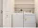 White washer and dryer in a laundry closet with shelves at 11596 W Sierra Dawn Blvd # 5, Surprise, AZ 85378