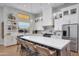 Modern kitchen with white cabinets, large island, and stainless steel appliances at 1410 E Blue Ridge Ct, Phoenix, AZ 85086