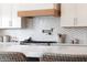 Kitchen detail showing wood range hood and chevron backsplash at 1410 E Blue Ridge Ct, Phoenix, AZ 85086