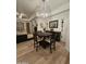 Cozy dining area featuring stylish chandelier and wood flooring at 14575 W Mountain View Blvd # 11210, Surprise, AZ 85374