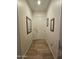 Inviting entryway featuring light wood floors and framed mirrors on the walls at 14575 W Mountain View Blvd # 11210, Surprise, AZ 85374