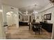 Bright, open-concept living room with light wood floors and elegant chandelier at 14575 W Mountain View Blvd # 11210, Surprise, AZ 85374