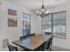 Traditional dining room featuring modern chandelier and expansive windows at 15114 W Turney Ave, Goodyear, AZ 85395