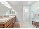 Bright bathroom boasts double sinks with granite countertops, wood cabinets, and a large, tiled shower at 1582 W Chicago St, Chandler, AZ 85224