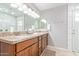 Bright bathroom boasts double sinks with granite countertops, wood cabinets, and ample counter space at 1582 W Chicago St, Chandler, AZ 85224