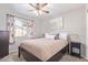 Bedroom features a ceiling fan and a window with decorative curtains at 1582 W Chicago St, Chandler, AZ 85224