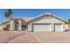 A well-maintained single-story home with a three-car garage and desert landscaping in front at 1582 W Chicago St, Chandler, AZ 85224
