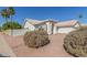 Single-story home with a three-car garage, desert landscaping, and an arched entryway at 1582 W Chicago St, Chandler, AZ 85224