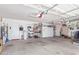 Spacious two car garage featuring storage shelving, work space, and garage door at 1582 W Chicago St, Chandler, AZ 85224