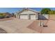 This home has a three-car garage with a long driveway and low maintenance desert landscaping at 1582 W Chicago St, Chandler, AZ 85224