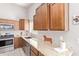 Charming kitchen with granite counters, stainless steel appliances and warm wood cabinets at 1582 W Chicago St, Chandler, AZ 85224